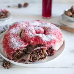 Dolce a spirale con ripieno di frutta e noci, spolverato di zucchero a velo, ricorda una rocciata umbra.