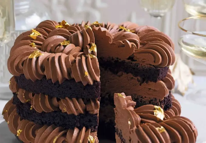 Torta a strati con pan di spagna al cacao, ricoperta da una golosa crema al cioccolato e decorata con foglia d'oro.